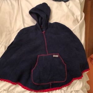 Navy blue cape with red stitching.